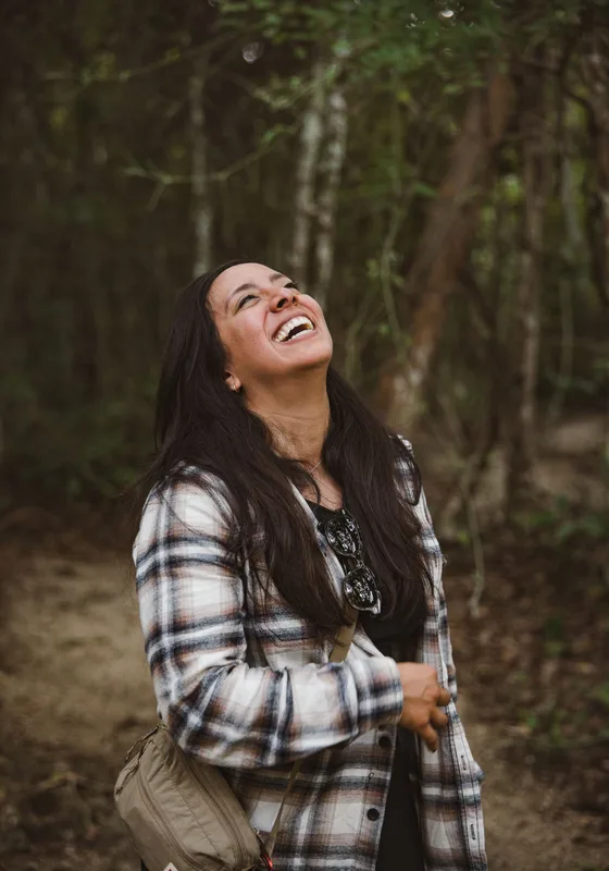 Woman laughing in a forest