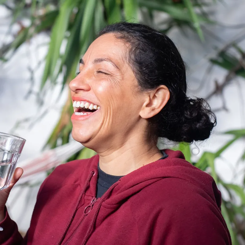 Woman laughing holding a glass