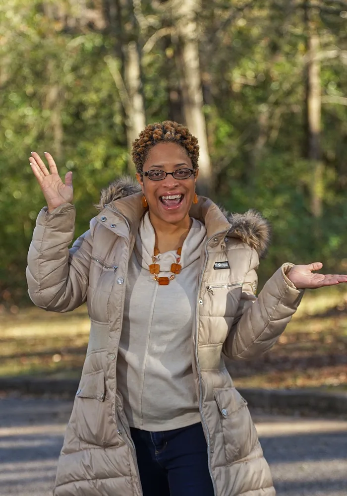 Woman laughing outdoors in a winter coat